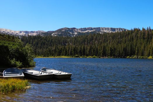 fishing boat docked in a calm lake of dreamy scenery.