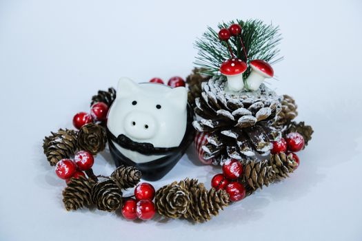 A baby mini-pig under a Christmas Tree with presents, symbolizing the upcoming 2019 New Year Year of a Pig 