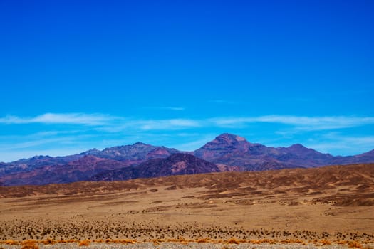 Different layers of Death Valley National Park with colorful mountains and sand dunes, USA