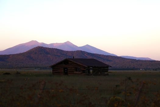 Old house in Arizona against the backdrop of the mountains during sunset