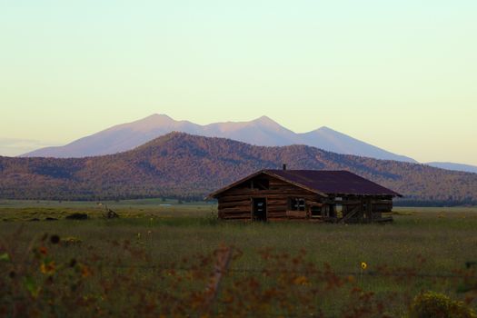 Old abandoned house on a background of mountains