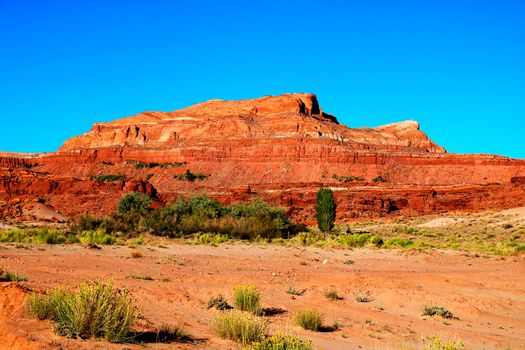 Desert landscape in Northern Arizona on the Navajo Reservation with distant rock peak