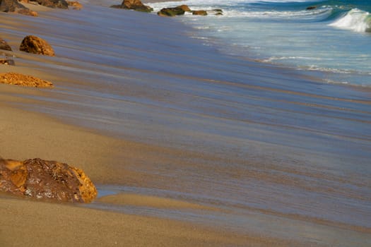 Soft wave of the sea on a sandy beach. Los Angeles, USA