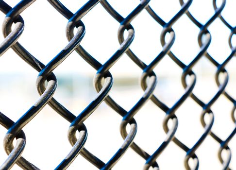 Close up mesh fence against the sky, background, pattern