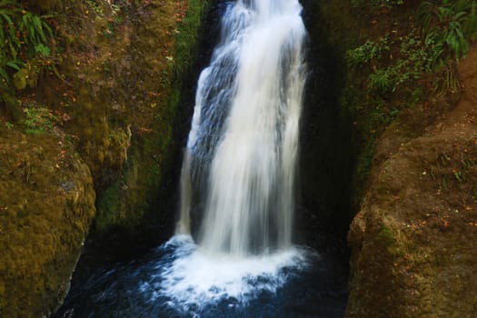 View of a small waterfall on a sunny day, USA. Background