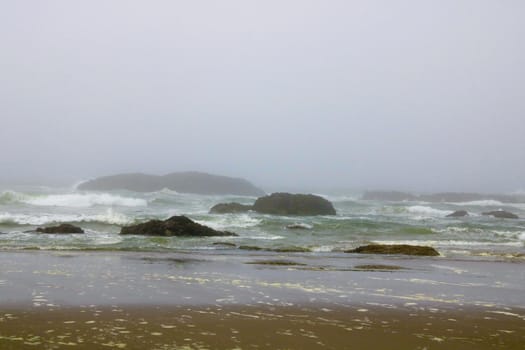 Coast of the Pacific Ocean with a beautiful beach on a foggy morning.