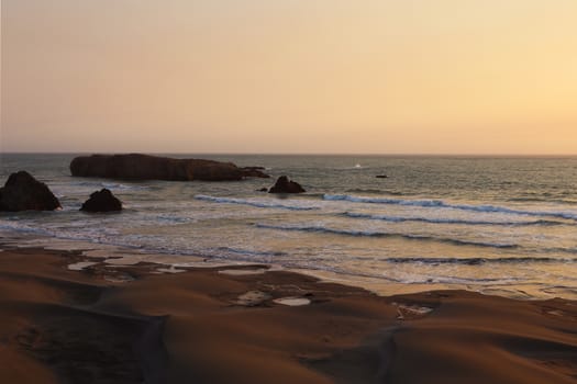 Sandy coast of the Pacific Ocean during sunset, sunrise.