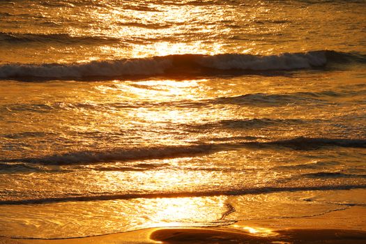 View of the sunset in the waves of the Pacific Ocean.