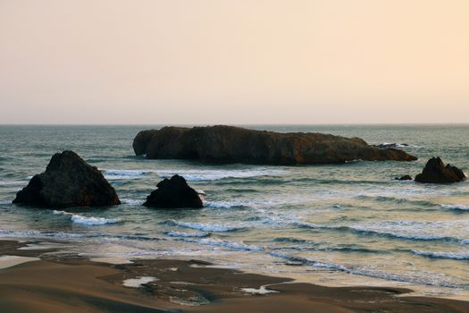 Cliffs on the coast of the Pacific Ocean during sunset in summer.