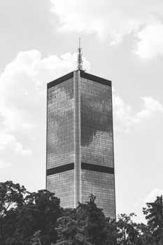 High modern office building in the city center of Warsaw in black and white color.