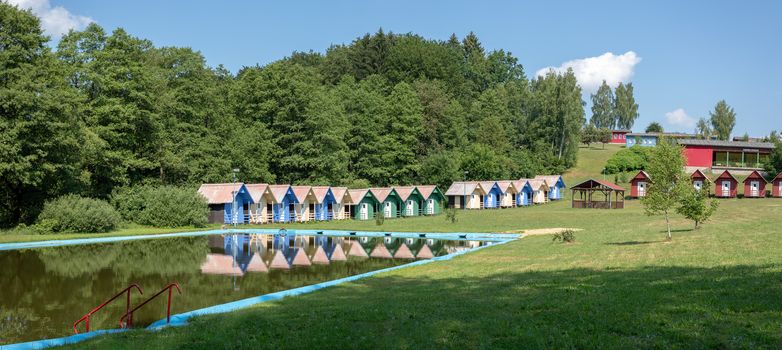 beautiful blue chalets in a summer camp for children situated near pond