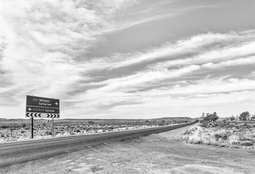 A directional road sign on road R63 near Williston in the Northern Cape Province of South Africa. Monochrome