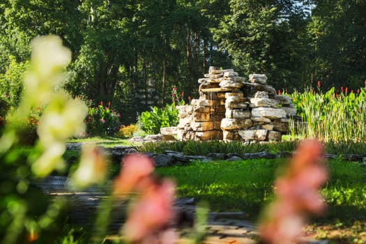 Beautiful man-made falls from a stone made the person in a garden.