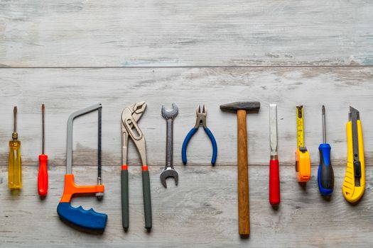 Screwdriver,hammer,tape measure and other tool for construction tools on rustic wooden background with copy space,industry engineer tool concept.still-life.