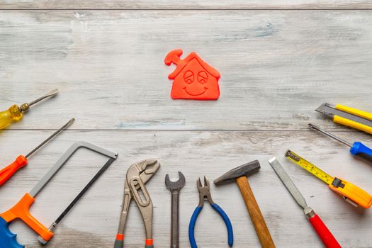 Set of work tool on gray wooden background with icon of house in space, industry engineer tool concept.