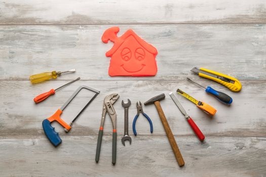 Set of work tool on rustic wooden background with icon of house in space, industry engineer tool concept.