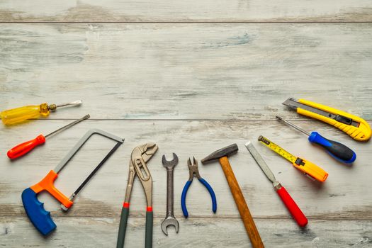 Screwdriver,hammer,tape measure and other tool for construction tools on rustic wooden background with copy space,industry engineer tool concept.still-life.