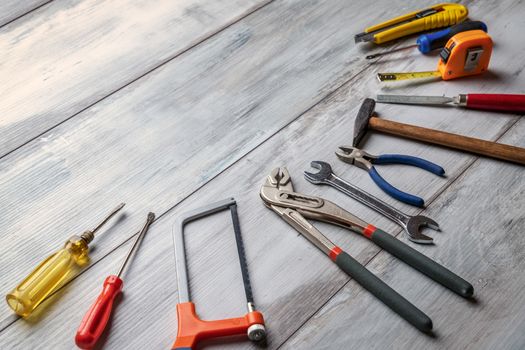 Screwdriver,hammer,tape measure and other tool for construction tools on gray wooden background with copy space,industry engineer tool concept.still-life.