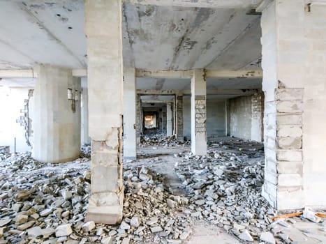 The ruins of a large destroyed building, pieces of stone, concrete, clay and metal