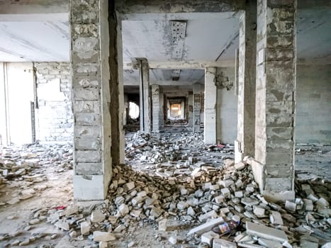 The ruins of a large destroyed building, pieces of stone, concrete, clay and metal