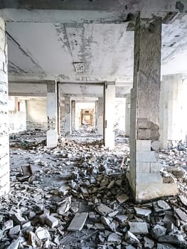 The ruins of a large destroyed building, pieces of stone, concrete, clay and metal