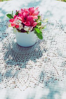 flowers bouquet on wooden garden table