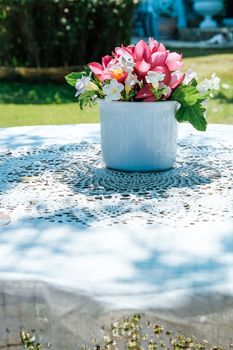 flowers bouquet on wooden garden table