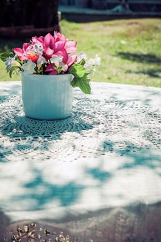 flowers bouquet on wooden garden table