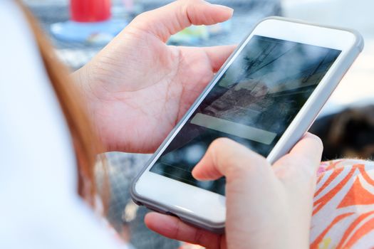 Teenage girl using white mobile phone