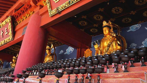 Burning big red candles in Buddhist temple in China