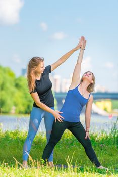 Individual yoga classes with a young experienced trainer in the park