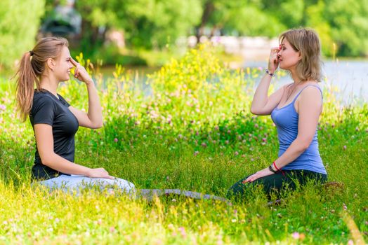 meditation and breathing exercises yoga in the park with a trainer