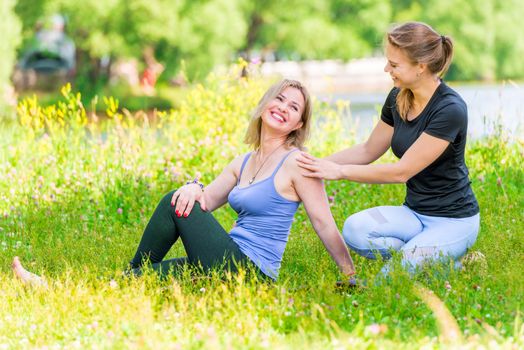 Mature woman with coach relax in the park after training, joking and laughing