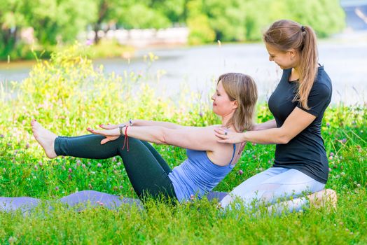 doing yoga exercise with an individual experienced trainer in the park