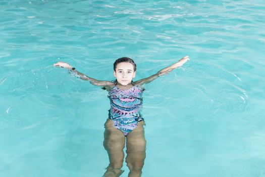 Beautiful girl swim and having fun in water.Active holiday.Girl swim in the pool. Happy girl play in the pool.