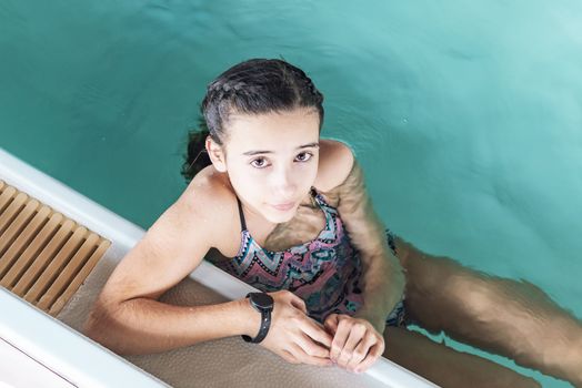 Beautiful girl swim and having fun in water.Active holiday.Girl swim in the pool. Happy girl play in the pool.