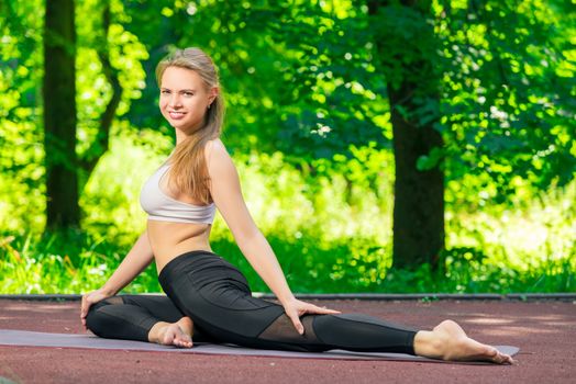beautiful woman during a pilates workout, healthy lifestyle in the park