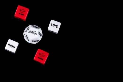 Cube with sexy poses, Kama Sutra. Toys for adults. Sex toys. Cubes with Kama Sutra poses for sex games. Playing cubes of red and white color for sexual games.Free space, copy space.