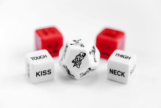 Cube with sexy poses, Kama Sutra. Toys for adults. Sex toys. Cubes with Kama Sutra poses for sex games. Playing cubes of red and white color for sexual games.Free space, copy space.
