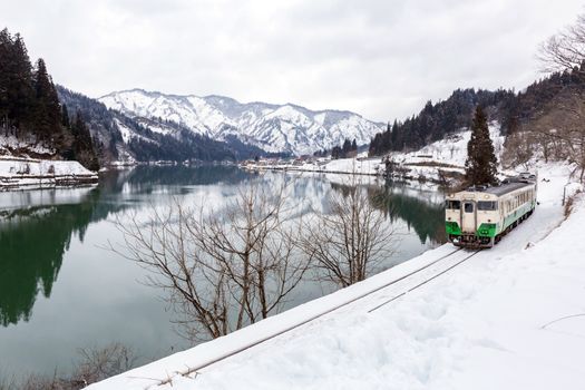 Train in Winter landscape snow on bridge