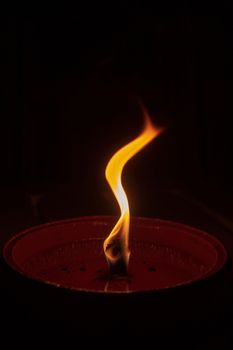 Candle flame close up on dark background, interesting flame figure, candle fire shape s form