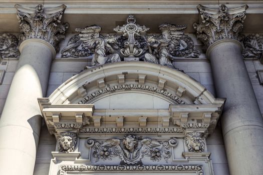 A close-up exterior view on a sculptural composition above the entrance of Dom Berliner, also known as the Berlin Cathedral in the historic city of Berlin in Germany.