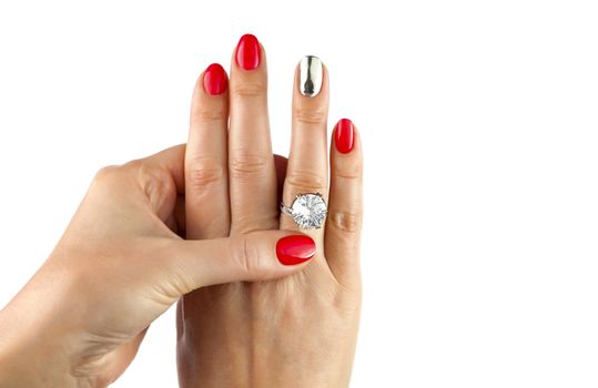 Female hands with red manicure wear a silver ring, isolated on white background
