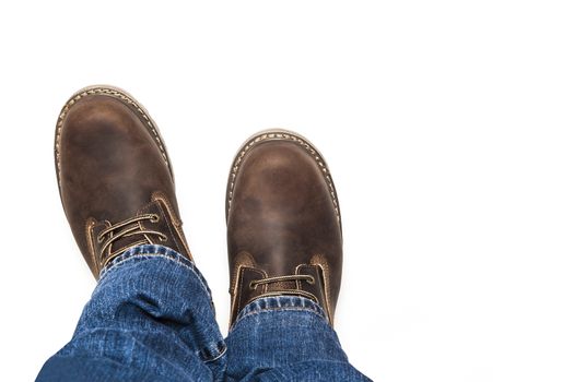 Men's brown boots and blue jeans. Isolated on white bacground