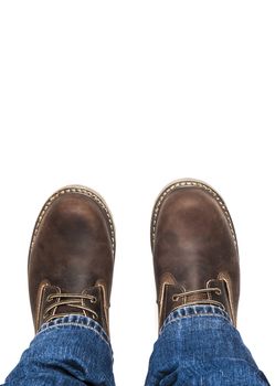 Men's brown boots and blue jeans. Isolated on white bacground