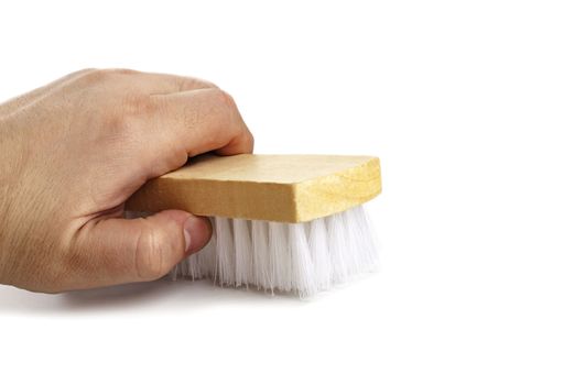 Brush for clothes in a man's hand close-up isolated on white background