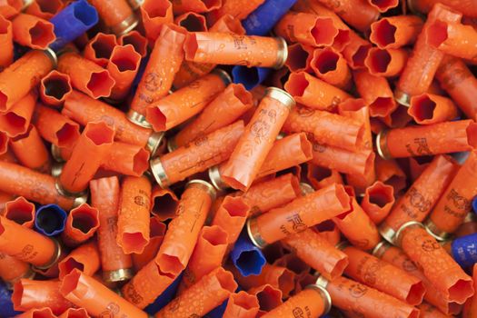 CHISINAU, MOLDOVA - October 3, 2018: Shotgun shells. Background of many colorful shot empty shotgun shells, blue, red, yellow, purple colored