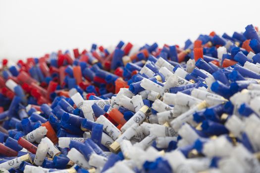 CHISINAU, MOLDOVA - October 3, 2018: Shotgun shells. Background of many colorful shot empty shotgun shells, blue, red, yellow, purple colored