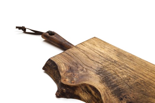 Surface of the old wooden planks kitchen board with leather strap, isolated on white background