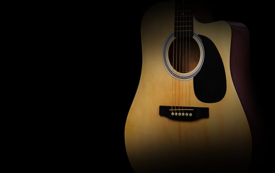 Part of acoustic guitar on old black background, concept